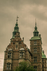 Historic architecture with towers and intricate details in Denmark under a cloudy sky