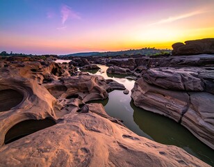 Dramatic rock formations in a river at sunrise