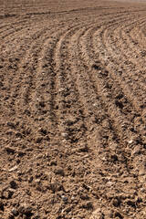 brown plowed soil, a field after harvest, a large field where agricultural activity is carried out in Europe