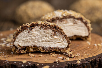 halved sweet marshmallows in chocolate sprinkled with waffle crumbs, sweet dessert marshmallows in chocolate with crumbs cut in half