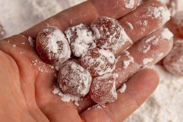 dry kumquat and powdered sugar, sweet dried orange kumquat fruits in white powdered sugar