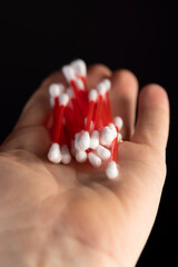 red sticks with white cotton for hygienic procedures, red plastic sticks with white cotton at the ends for personal hygiene