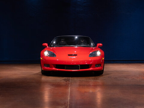Red Chevrolet Corvette C6 supercar front view, Symmetrical studio shot of an american muscle car

