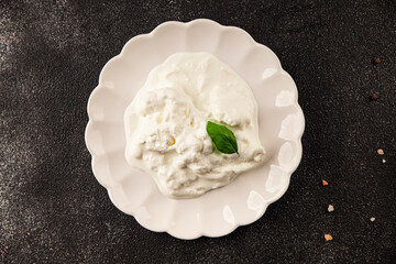 Stracciatella cheese soft young portion size Italian food natural product tasty snack fresh delicious gourmet food background on the table rustic top view copy space