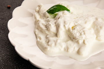 Stracciatella cheese soft young portion size Italian food natural product tasty snack fresh delicious gourmet food background on the table rustic top view copy space