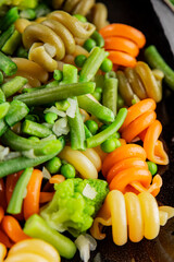 Trottole pasta vegetables green peas, green beans, kohlrabi cabbage, broccoli second course tasty snack fresh delicious gourmet food background on the table rustic food top view copy space