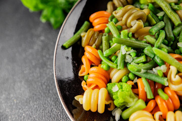 Trottole pasta vegetables green peas, green beans, kohlrabi cabbage, broccoli second course tasty snack fresh delicious gourmet food background on the table rustic food top view copy space