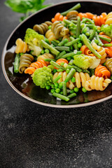 Trottole pasta vegetables green peas, green beans, kohlrabi cabbage, broccoli second course tasty snack fresh delicious gourmet food background on the table rustic food top view copy space