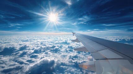Airplane wing over a vast expanse of clouds, bright sun