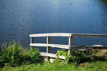 Tranquil Lakeside Scene with Rustic Wooden Fence at Clumber Park, Nottinghamshire, England: A Peaceful Countryside Retreat