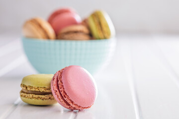 Different flavors of macarons. Colourful macaroons on white table.