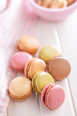 Different flavors of macarons. Colourful macaroons on white table.