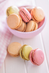 Different flavors of macarons. Colourful macaroons on white table.