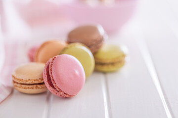 Different flavors of macarons. Colourful macaroons on white table.