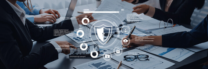 Business team collaborating on data analysis with cybersecurity icons, digital shield overlay, modern office setting, technology integration, teamwork dynamics. Trope.