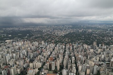 Urban skyline of Sao Paulo shows sprawling cityscape and cloudiness