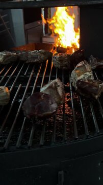 Grilled meat sizzling on a street barbecue, with flames dancing and smoke rising, showcasing a vibrant urban cooking scene filled with delicious aromas and textures