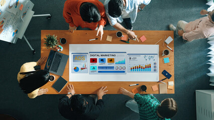 A diverse group of professionals collaborates in a modern office setting, sharing ideas and...