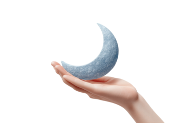 Caucasian female hand holding crescent moon sculpture against black background, cut out
