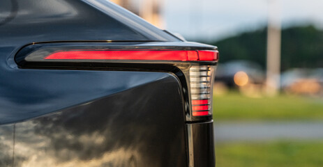 Modern car tail light detail at dusk.