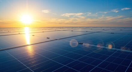 Vast solar panel array reflecting the golden sun and blue sky at sunset