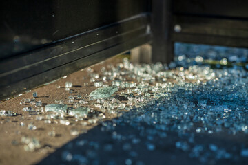 Shattered glass remains near dark metal structure.