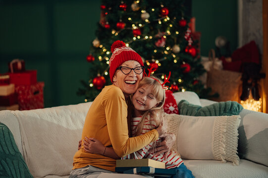 Grandmother and granddaughter hugging on christmas eve