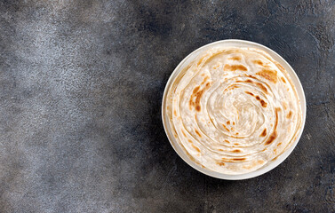 Indian paratha flatbreads on gray background. Indian food. Top view. Copy space.