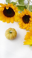 Sunflowers with Pumpkin-Shaped Candle on White Background