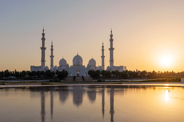 Sheikh Zayed Grand Mosque in Abu Dhabi at sunset. Stunning Islamic architecture, peaceful reflection on water, symbol of spirituality, culture, and UAE elegance