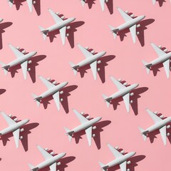 Seamless pattern of white toy fighter jets arranged on a pastel pink background