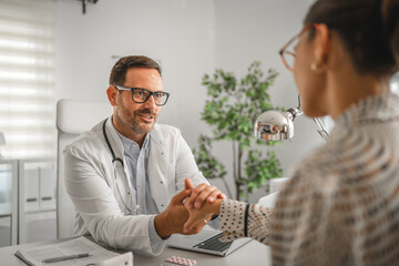 Doctor holding patient's hand offering medical support and empathy