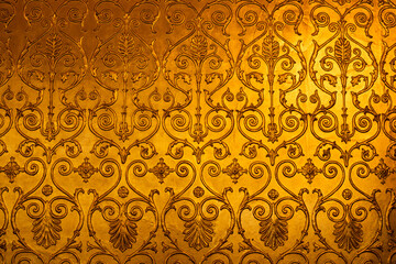 golden ornamental pattern with floral and scroll details creating a luxurious decorative texture background