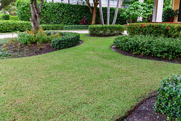 Sleek garden tiers along walkway. Simple and elegant front yard.
