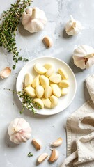 Sliced garlic cloves on a plate, surrounded by whole heads of garlic and fresh thyme sprigs