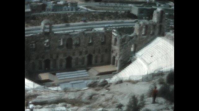 The Odeon of Herodes Atticus 1964 - The Odeon of Herodes Atticus, the ruins of an ancient Roman theater on the southwest slope of the Acropolis, is seen from the Acropolis, in Athens, Greece, 1964.