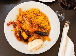 Delicious spanish fideua dish with seafood served on plate