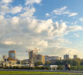 A cityscape with modern buildings and blue skies.