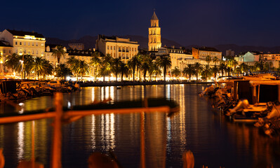 Fototapeta premium Summer evening on embankment of port city. On coast of Adriatic Sea is port of Split. Parking of watercraft in Adriatic Sea, parking place for yachts and ships...