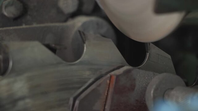 Close-up of a Circular saw sharpening process at the modern factory. Automated Grinding equipment is sharpening the blade of a circular saw. Circular machine used for saw blade sharpening. Production.