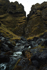 Vertical view of Raudfeldsgja Gorge with a river in the foreground