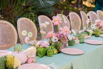 Elegant Outdoor Table Setting with Pastel Flowers, Fresh Vegetables, and Delicate Glassware Perfect for a Special Gathering or Celebration
