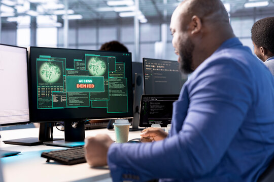 Access denied popup notification received by man trying to optimize server hub. African american data center IT expert failing to eliminate network errors, struggling at work - Powered by Adobe