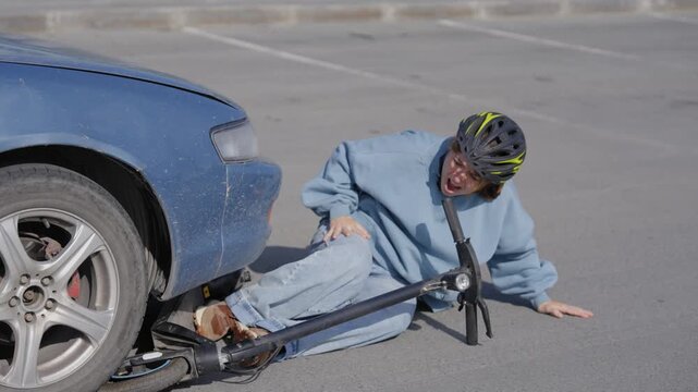 A Caucasian woman on a scooter after being hit by a car.