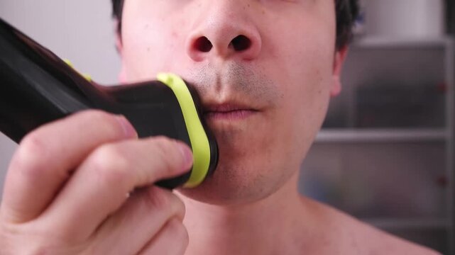 Video of a man shaving his face to remove any beard stubble, a topic of hygiene and personal image