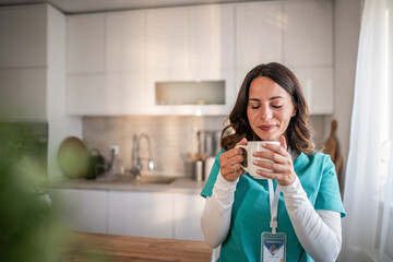 Healthcare worker enjoying coffee break in kitchen