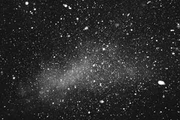 A black and white image of falling snow