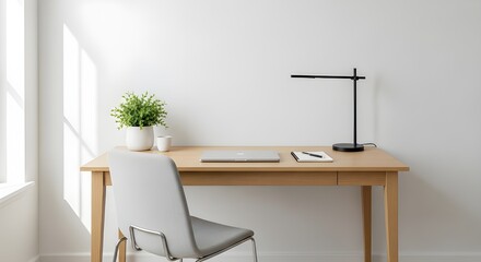Fototapeta premium Minimalist workspace setup with laptop, notebook, and plant bathed in natural light