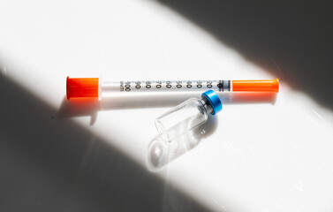 Close up of Empty Vial with Injectable Compounds Next to Syringe
