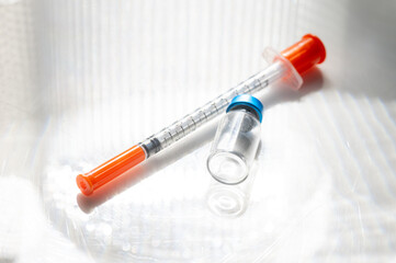 Close up of Empty Vial with Injectable Compounds Next to Syringe
